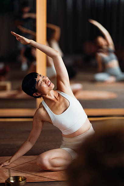 istock Graceful Yoga Pose in Studio Class With Focused Instructor and Other Participants 2244668457