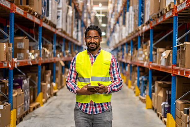 istock Warehouse worker standing in aisle managing inventory with tablet 2244670905