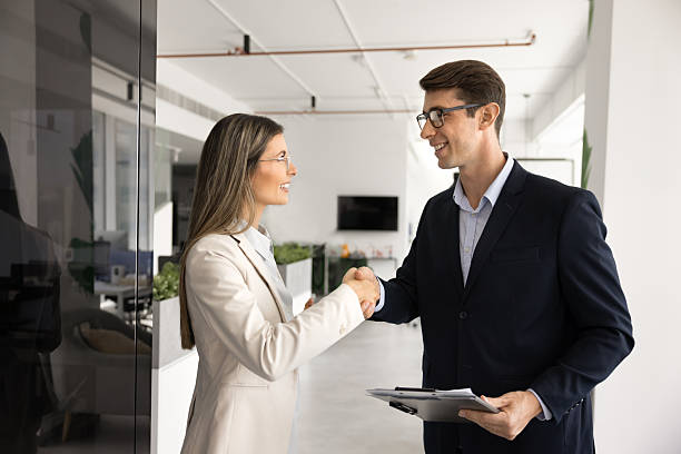 istock Two positive young Latin business colleagues giving handshake 2244671348