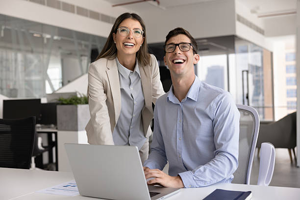 istock Two cheerful young Hispanic managers meeting at laptop 2244672122