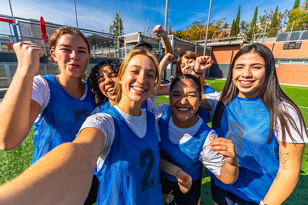 istock Diverse women's soccer team celebrating victory with a selfie 2244672557