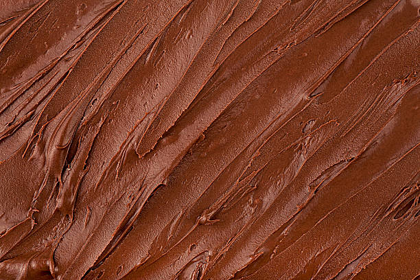 istock Chocolate hazelnut spread as background, top view. Chocolate cream texture. 2244673339