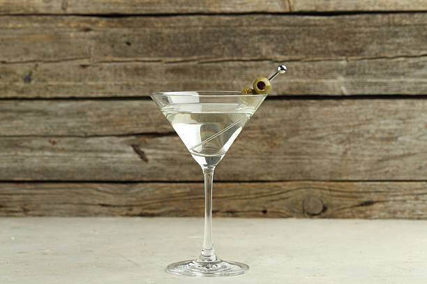 istock Martini cocktail with olives in glass on light table 2244676057
