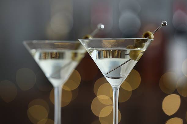 istock Martini cocktail with olives in glasses on blurred background, closeup. Bokeh effect 2244676141