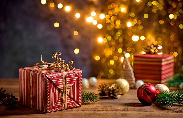 istock beautiful Christmas Greeting card with wrapped gift box and blurred lights 2244676676