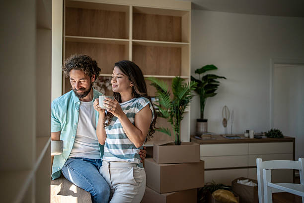 istock Couple relaxing in new home enjoying coffee break 2244676771
