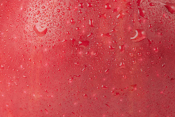 istock Texture of red ripe apple with drops as background. 2244677378