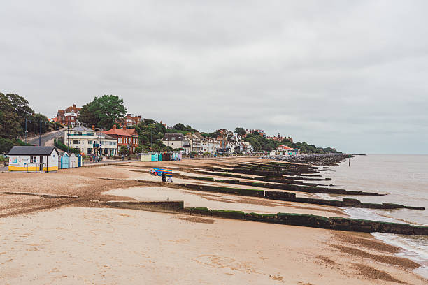 Felixstowe beach showcasing a line of groynes and vibrant beach huts