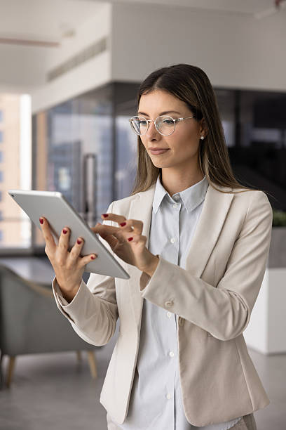 istock Young female business expert woman using gadget for work communication 2244681130