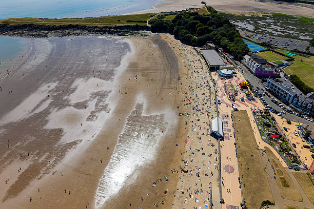 Aerial drone view of crowds enjoying a sunny day at Barry Island beach, Wales