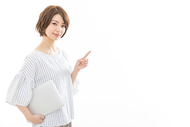 istock A woman holding a laptop and pointing 2244682367