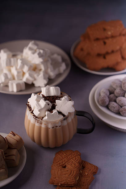 istock cozy autumn treats with hot chocolate, star-shaped marshmallows, and assorted biscuits and confections creating a warm and inviting culinary display, comfort, appetizing, contrast, light, dark 2244682748