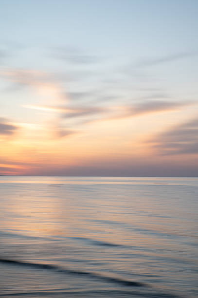 istock Artistic Blurred Background of Sea, Sky and clouds during a soft colours sunset. Copy space. 2244683793