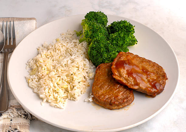 istock salisbury steak  with  broccoli and rice 2244684723