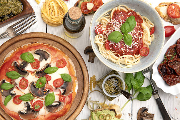 istock Pizza margherita and spaghetti with tomato sauce on white rustic table 2244684799
