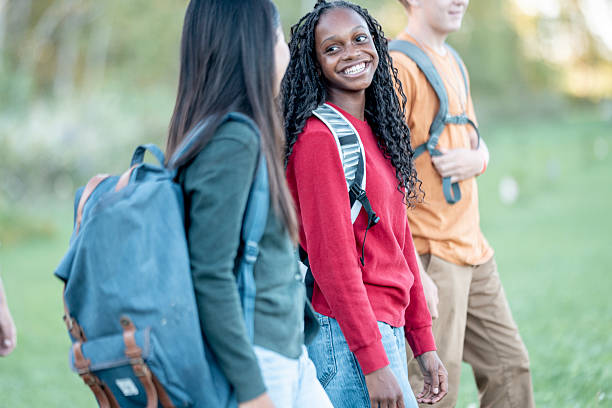 istock Diverse Group of Teens Walking Outdoors With Backpacks, Smiling and Engaged in Conversation 2244685580