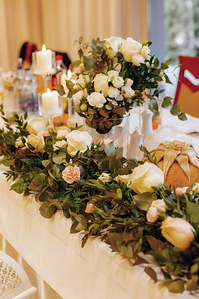 Floral table decorations with elegant flowers arranged for a party or wedding, creating a festive and stylish atmosphere for guests