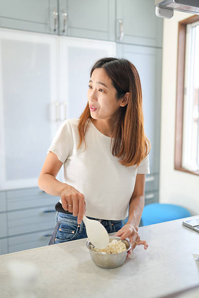 A woman is preparing food on a countertop