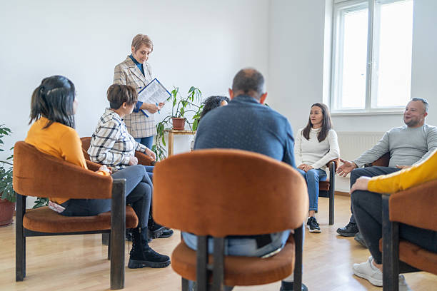 istock Counselor leading group therapy session for adults struggling with addiction 2244688179