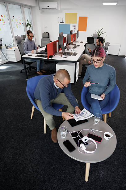 istock Business professionals collaborating in a modern office space during a team meeting focused on project planning and strategy 2244688394