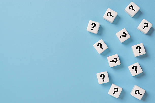 istock Many question mark signs on dice on blue paper background with copy space 2244691838