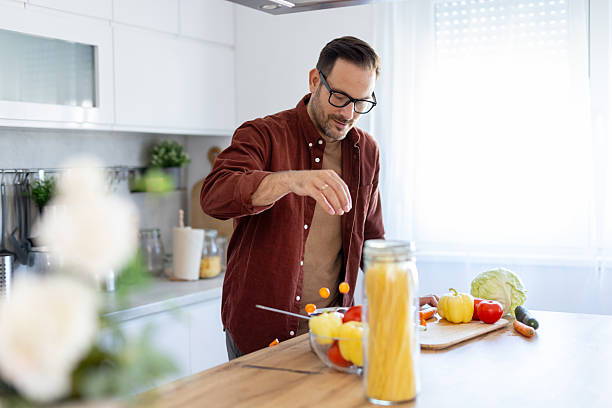 istock Joyful cook preparing healthy ingredients in modern kitchen 2244694246