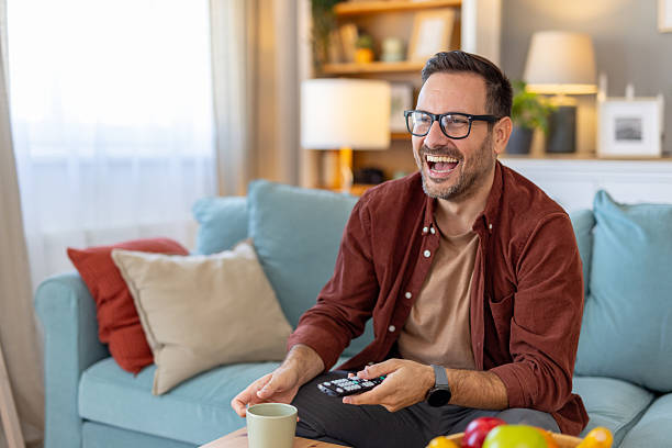 istock Man Enjoying Relaxing Moments While Watching TV at Home 2244694272