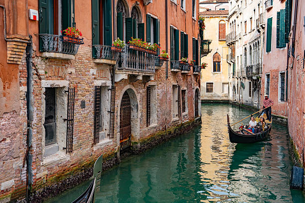 Gondola Sailing in the Venetian Canals with tourist, Venice, Italy.