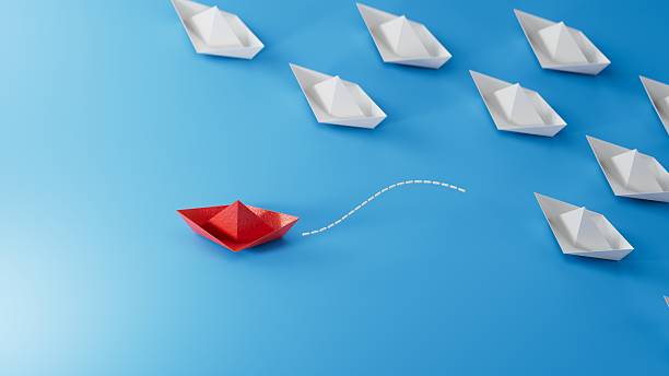 istock Different business concept.new ideas. paper art style. creative idea.red leader boat, standing out from the crowd of white boats.3D rendering on blue background. 2244700583