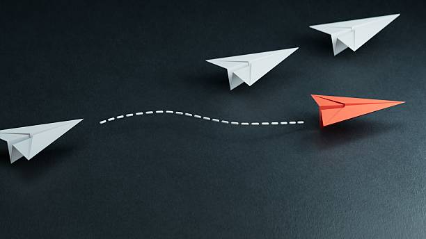 istock Different business concept.new ideas. paper art style. creative idea.red leader plane, standing out from the crowd of white planes.3D rendering on black background. 2244700608
