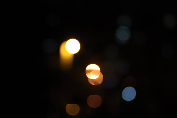 A close-up view of blurred lights with various colors creating a soft and dreamy visual effect in the dark.