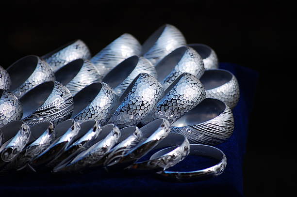 A display of Navajo culture silver and stone bracelets for sale at a vintage flea market