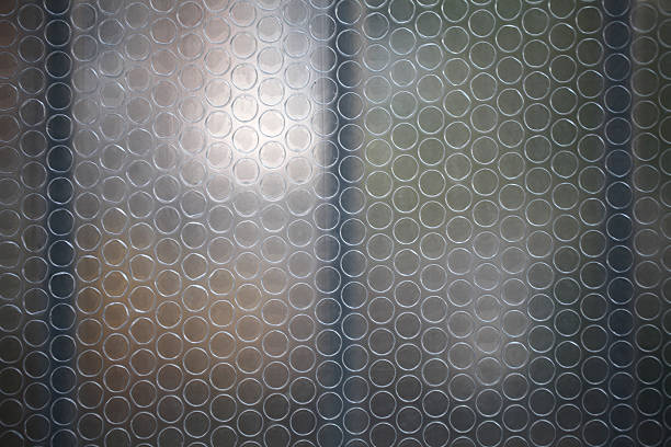 Close-up of a surface featuring a repeating circular pattern in a monotone color scheme.