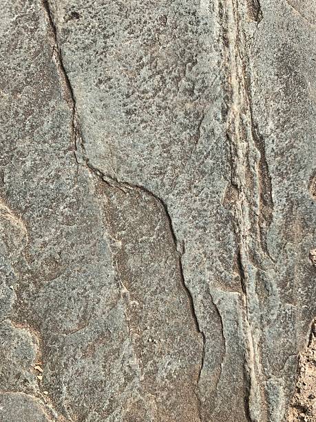 istock Close-up view of a rough rock surface with natural patterns 2244702710