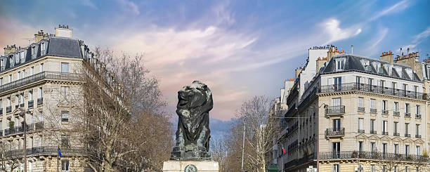 Paris, France, beautiful lion place Denfert-Rochereau in the 14e arrondissement, with typical buildings