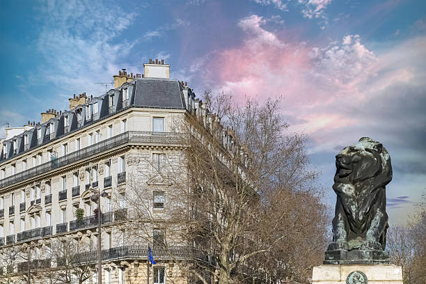 Paris, France, beautiful lion place Denfert-Rochereau in the 14e arrondissement, with typical buildings