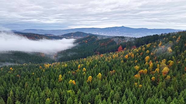 istock distant peaks under cloudy sky, aerial shot capturing misty valleys and remote mountain silhouettes 2244710404