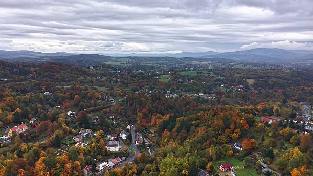 istock skyline fall view, aerial view of suburban area during fall with vibrant trees and rooftops visible 2244710808
