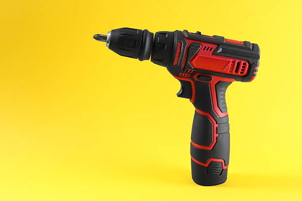 istock Modern electric screwdriver on yellow background. Space for text 2244712081