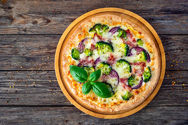 istock Circle pizza broccoli with bacon and mozzarella cheese on wooden background 2244715433
