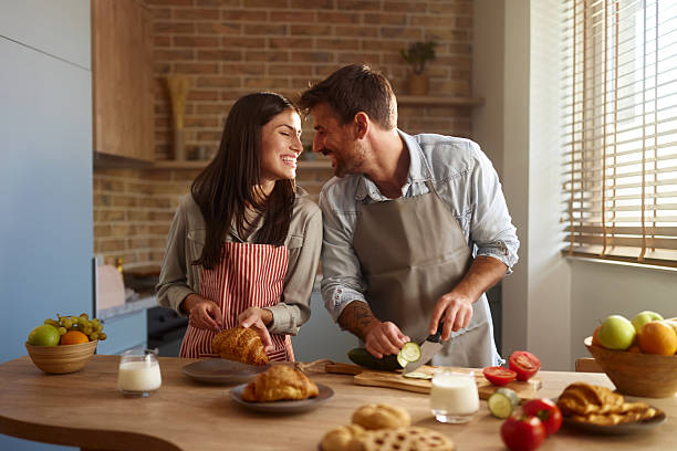 istock Happy couple talking while preparing a meal in the kitchen. 2244726134