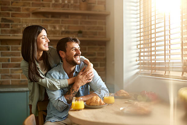 istock Happy couple day dreaming during breakfast at home. 2244726541