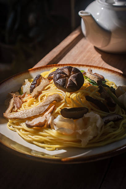 istock A rustic vegetarian noodle dish served with shiitake mushrooms, set amidst warm natural light, perfect for promoting vegan, Asian, food menus and healthy lifestyle concepts with its beautiful rustic presentation. 2244727628
