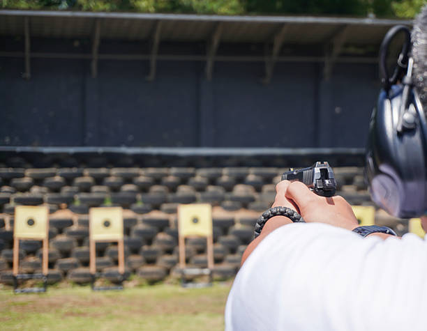 istock Shooters Focus Gun at target range with precision with skill  safety. 2244728235