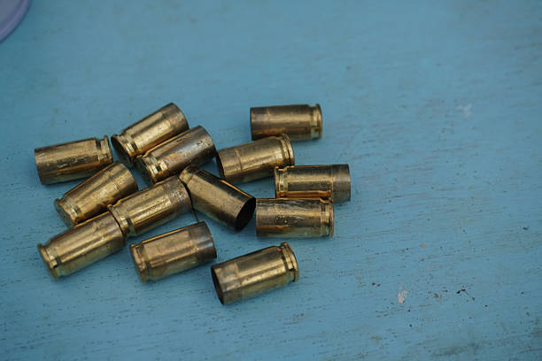 istock Spent Casings Echoes of gunfire on weathered blue backdrop. 2244728283