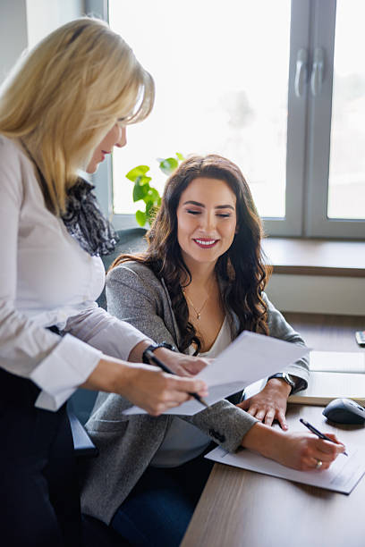 istock Beautiful businesswomen comparing financial documents in the office 2244728480
