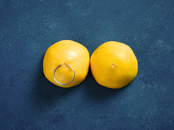 istock Lemons representing breasts with a body piercing concept 2244728494