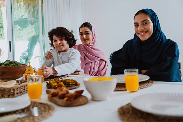 istock Muslim family members playing a game during eid celebration meal 2244729777