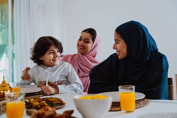 istock Muslim family members playing a game during eid celebration meal 2244729788