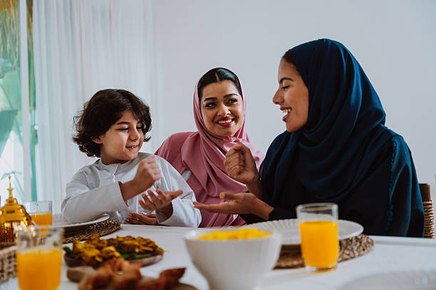 istock Muslim family members playing a game during eid celebration meal 2244729796